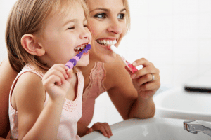 mother-daughter-brushing-teeth